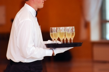 waiter with dish of vine glasses © Alexander Kataytsev